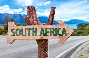 South Africa wooden sign with road background