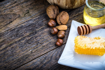 honey dipper and honeycomb, nuts of various kinds