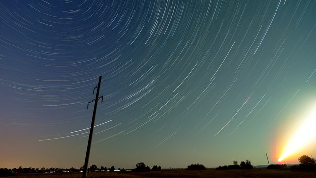 Time lapse of a electricity pylon in front of Startrails