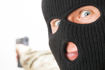 Crazy man in black mask holding gun