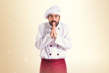 Chef pleading over white background