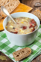 Sour soup with bread.