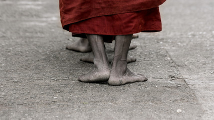 Foots of ascetic Buddhist monk walking at the way to  Kyaikhtiyo