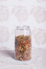 glass jar with small colored pasta