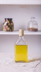 glass bottle of tequila is on the table, in the kitchen