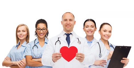 group of smiling doctors with red heart shape