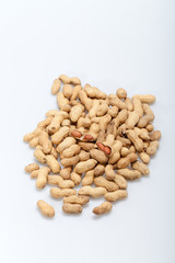 .Dried peanuts in closeup on the white background