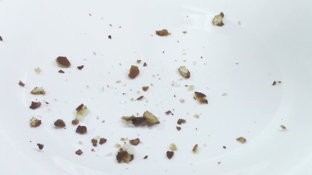 Crumbs falling on white plate