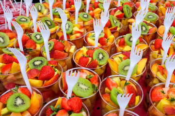 Fruit Salad arranged in plastic cups on a market stall