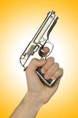 Naklejka premium Gun in the hand on white