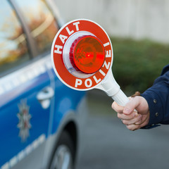 polizist zeigt die haltekelle