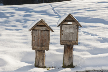 Zwei originelle Briefkästen in Winterlandschaft, Schweiz