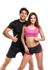 Athletic couple - man and woman with thumb up on the white