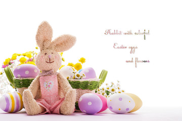 Soft toy in the shape of a rabbit with colorful Easter eggs and