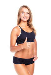 Fototapeta premium Young athletic girl with a finger up on white