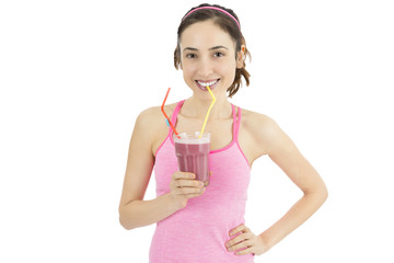 Attractive sporty woman drinking smoothie
