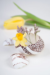 Easter decorations on neutral background in white, yellow and gr
