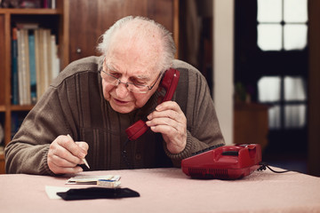 Senior at old telephone