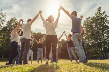 Group of ten friends at the park holding hands - obrazy, fototapety, plakaty