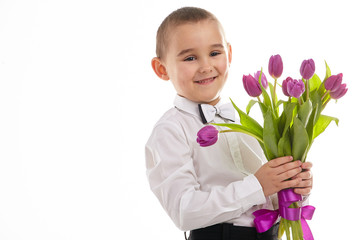 smiling little boy giving tulips