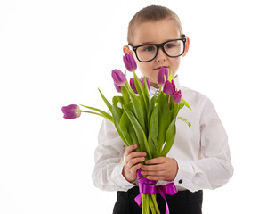 smiling little boy giving tulips