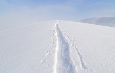 Trail in the snow in the mountains