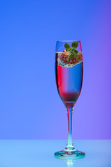 Champagne glass with strawberry, studio shot with light effects