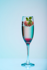 Champagne glass with strawberry, studio shot with light effects