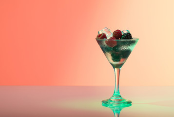 Raspberry and blackberry cocktail with ice, studio shot