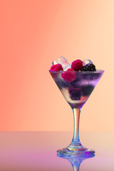 Raspberry and blackberry cocktail with ice, studio shot