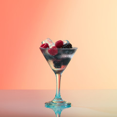 Raspberry and blackberry cocktail with ice, studio shot