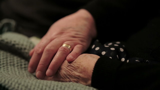 Closeup of an old woman's hands joined , focus on hands