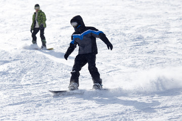 Fototapeta na wymiar Jumping snowboarder from hill in winter
