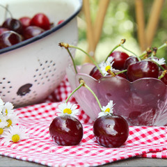 Sweet cherries on a wooden table in the garden