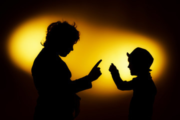 Two  expressive boy's silhouettes showing emotions using gesticu