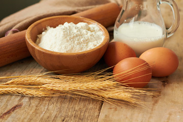 Fototapeta na wymiar Baking ingredients: eggs, milk, flour, rolling pin