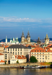 Obraz premium Roofs of Old Prague with famous towers on a bright summer day. T