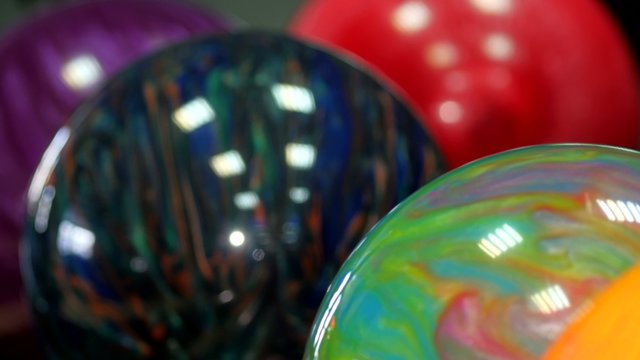 Colored bowling balls in the bollmachine. Сamera moves from
