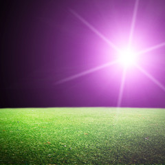 Shiny soccer ball in full stadium lights at night