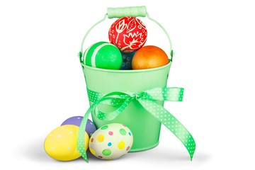 multicolored easter eggs in metal  pot with bow isolated on