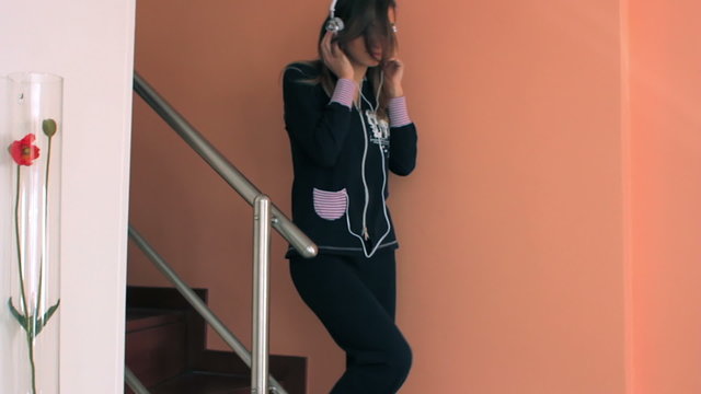 Young girl dancing while listen music at home