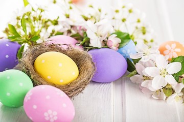 Fototapeta na wymiar colorful easter eggs and branch with flowers