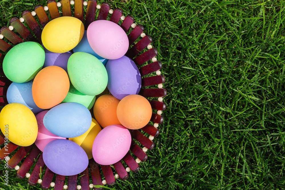 Sticker Colorful easter eggs in nest on meadow