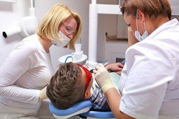 Doctor and nurse perform the procedure for dental treatment