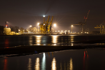 Fototapeta na wymiar Night view of a port with lights reflection in water, Swinoujscie, Poland.