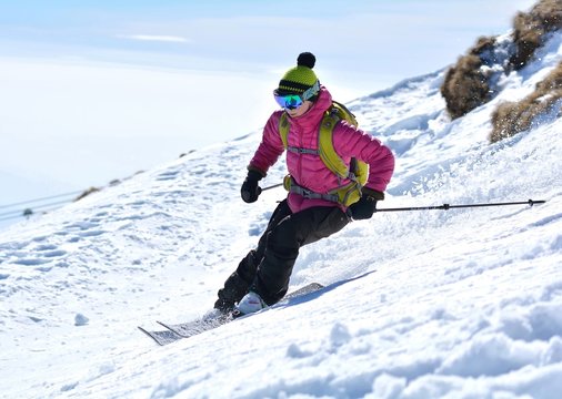 Winter sport - Woman skier in the soft snow, downhill skiing
