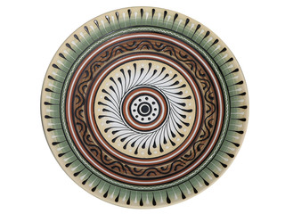 handmade ornated pottery plate isolated on white