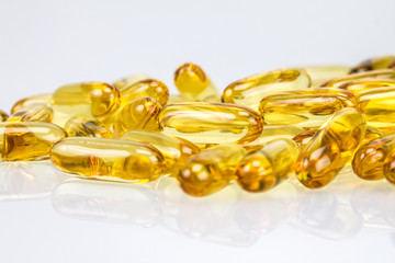 Closeup yellow soft gelatin supplement fish oil capsule