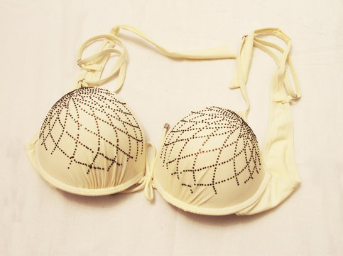 Light yellow bra isolated on the white background