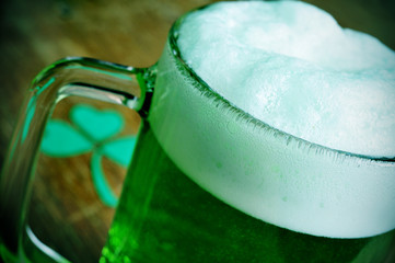 mug with dyed green beer and three-leaved shamrock, for saint pa